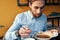 a man eats borscht with sour cream in a restaurant at a table in a cafe and a watch on his hand