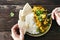 Man eats cauliflower spicy curry rice naan bread top view