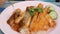 A man eats a fork with Thai food. Rice with pea pods and fried crispy chicken on breading