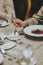 man eats red soup, sits at an elegantly served table in a restaurant, close-up. female hands with a spoon over red soup