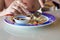 A man eats Thai food in a street cafe with a spoon and fork. Gastronomic tourism