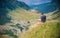 Man on the edge of abyss with picturesque view of Transfagaras mountain road in the Transylvanian Alps, Romania