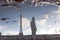 Man and the Eiffel tower reflected in a puddle