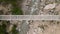 Man on electric bike crossing bridge in the mountains