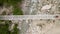 Man on electric bike crossing bridge in the mountains