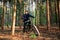 Man on an electric bike with thick wheels. Location pine forest. Healthy sports hobby. Black fatbike