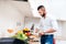 man with elegant shirt cooking dinner for girlfriend. Close up of kitchen cook cutting vegetables and preparing salad