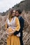 Man embraces and kisses the pregnant woman among dry reeds.