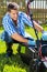 Man emptying lawnmower grass catcher