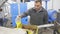 Man engaged in traditional olive oil production, controlling process of oil decanting