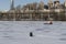 Man is engaged in winter fishing and a hovercraft Emercom and Lakhta Center