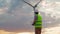 Man Engineer in uniform and helmet holding remote controller for flying drone working wind turbine. Alternative electrical energy