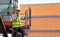 Man engineer using walkie-talkie in shipping yard, Industrial worker is controlling container loading by walkie talkie in import-
