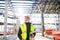 Man engineer with walkie talkie standing on construction site.