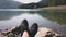 Man enjoy relax at tranquil lake pov shot of shoes background