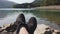 Man enjoy relax at tranquil lake pov shot of shoes panning background