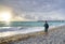 Man enjoying beautiful beach at sunrise.