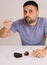 Man enjoying a chocolate cake with strawberry jam