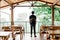 Man enjoying green natural scenery from Villa balcony