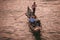 Man enjoying a peaceful gondola ride on the water in an unknown location