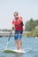 Man enjoying ride on lake with paddleboard