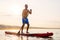 Man enjoying ride on paddle board