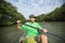 Man enjoying river kayaking through mangrove jungl
