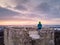 Man enjoying scenic sunset from Weissenstein ruined rock castle in Regen, Germany