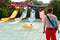 Man enjoying water attraction on yellow waterpark tube. Lifeguard looking pool at Aquatica Par