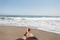 Man enjoys vacation lying on the beach. Guy relaxes near the blue ocean on a sunny day. Freelancer relaxes. Time relax.