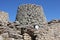 A man entering into a Nuraghe, a typical ancient rock building of the Sardinia island