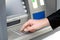 Man enters a PIN code and withdraws money from an ATM