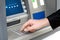 Man enters a PIN code and withdraws money from an ATM