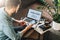 Man, entrepreneur, uses smartphone, working on laptop with inscription analysis on screen