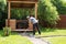 Man evens gravel on path with rake