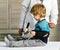 Man examines boy sitting on table on wooden background