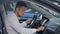 Man examines car interior at the dealership