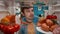 A man examines the filled shelves of the refrigerator. Portrait of a satisfied man, close up view from inside the