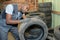 Man examining tread on dismantled tyre