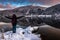 Man Excited by The Beauty of Lake and Mountains Landscape in Winter at Dusk