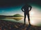 Man exercising on beach. Silhouette of active man exercising and stretching at lake