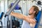 Man exercising at gym. Fitness athlete doing chest exercises on vertical bench press machine
