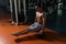 Man Exercising Handstand Push-Ups On Ball In Gym