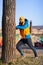 Man exercising next to the tree