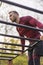 Man exercising in street workout park doing pull ups