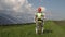 Man in exoskeleton walking in field near solar panels