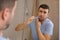 Man experimenting pain while brushing his teeth