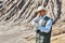 Man explorer in desert examines folding shovel