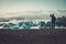 Man explorer lookig at Jokulsarlon lagoon, Iceland.