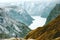 Man explorer raised hands at Naeroyfjord mountains